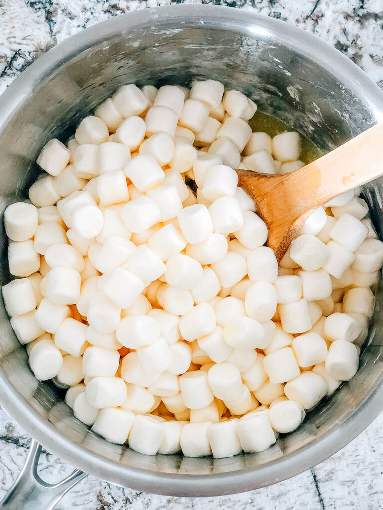A saucepan with melted butter and just coated mini marshmallows in it.