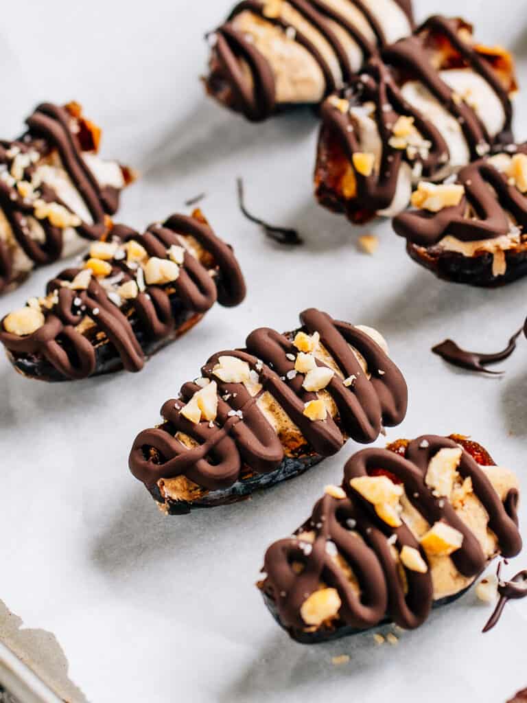 Date halves covered in almond butter and a drizzle of chocolate are these Date Snickers.