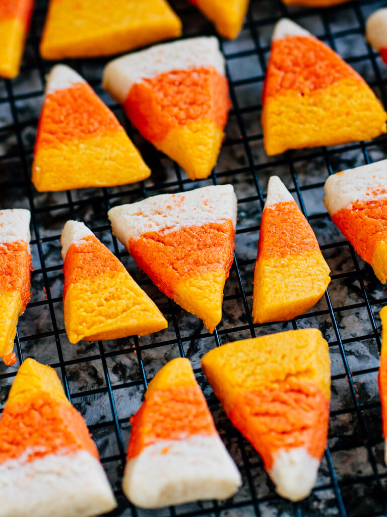 Candy corn cookies cooling on a rack.