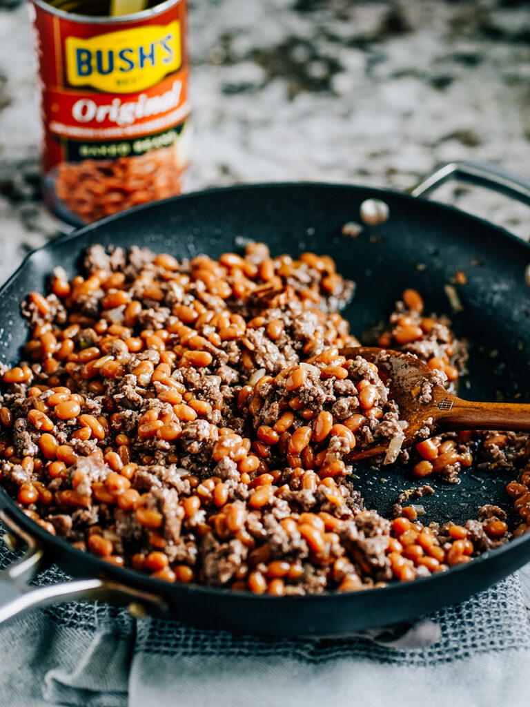 Baked beans and ground beef in a skillet.