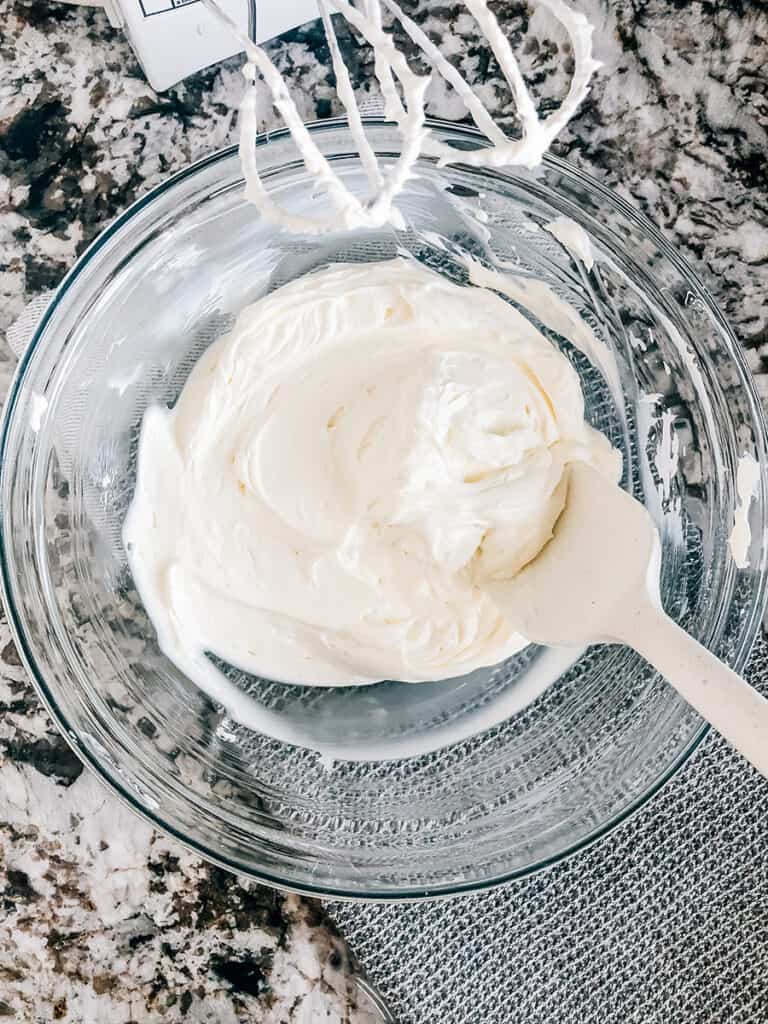 Sour cream and softened cream cheese beaten until smooth in a medium mixing bowl.