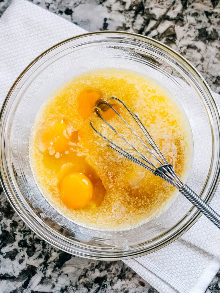 Melted butter, eggs, sugar, and vanilla all in a large bowl.
