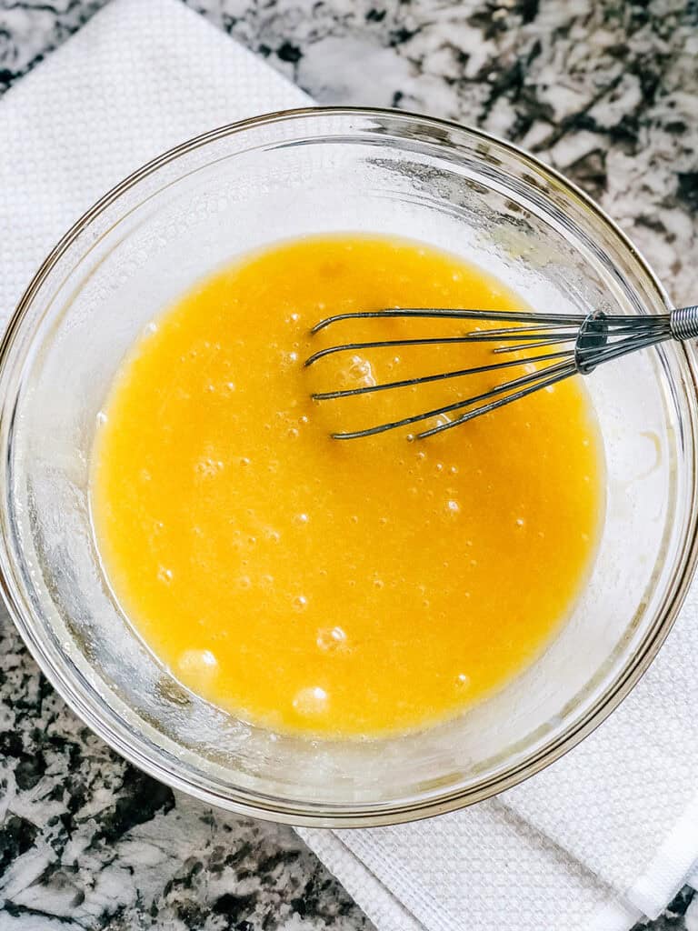 Whisked together eggs, melted butter, sugar, and vanilla.