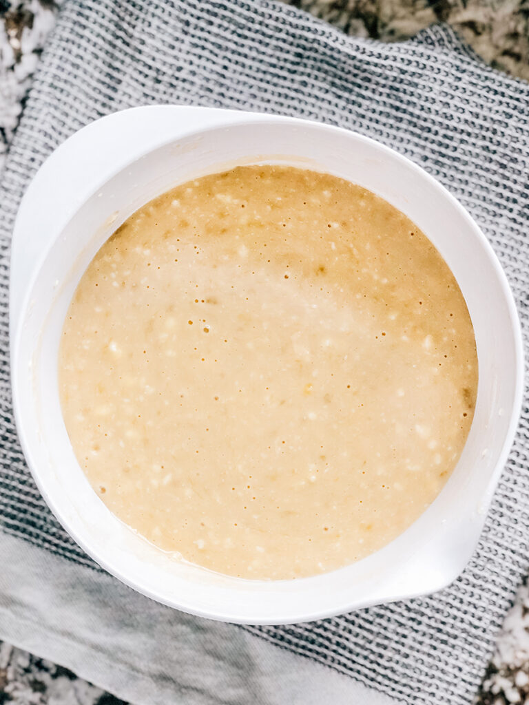 Completely mixed banana bread bar batter in a white mixing bowl