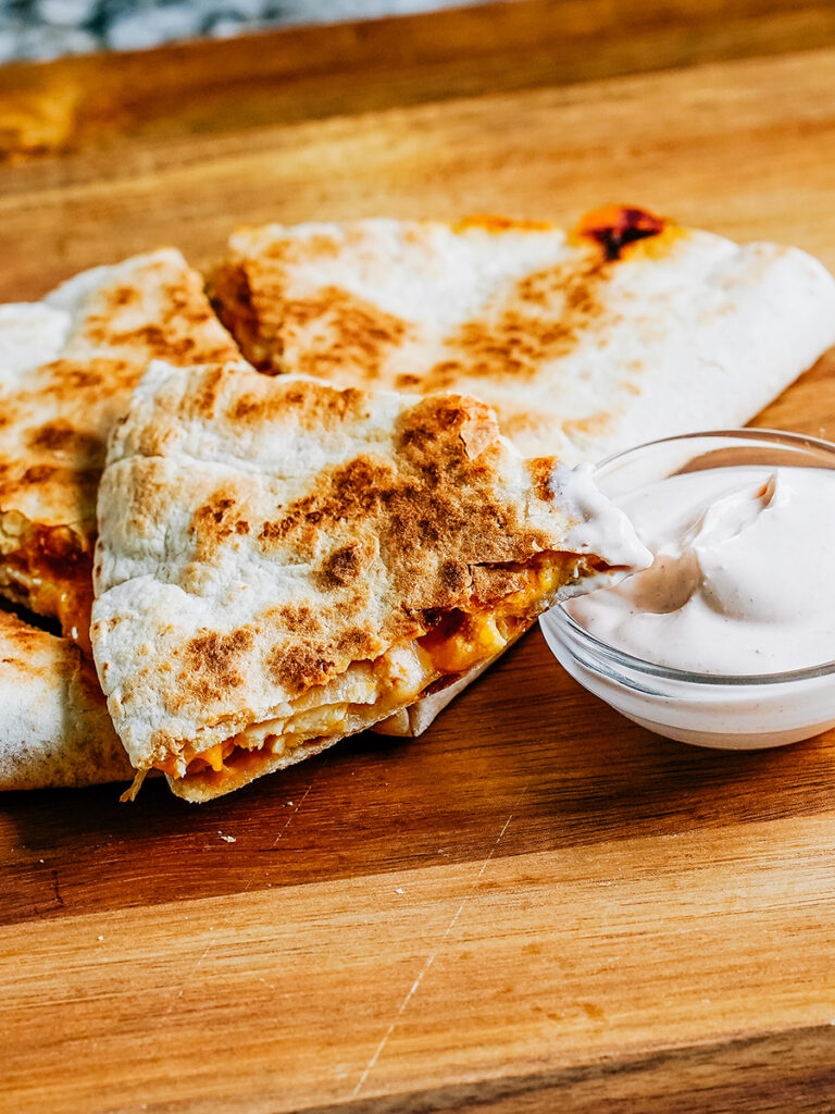 Complete easy chicken quesadilla dipping in more homemade quesadilla sauce.