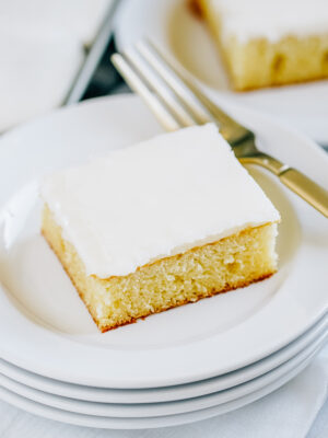 Easy White Texas Sheet Cake ready to eat on a plate.