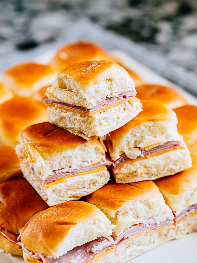 A pile of delicious and potable ham and cheese sliders.