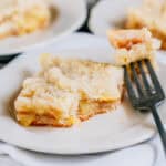 A fork cut into a homemade and delightful zucchini mock apple pie square platted.