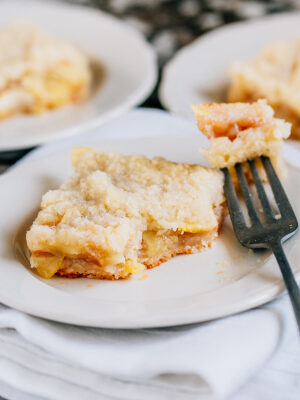 A fork cut into a homemade and delightful zucchini mock apple pie square platted.