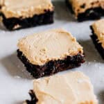 Single servings of delicious peanut butter brownies on parchment paper.