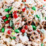 White chocolate coated pretzels, rice squares, and Cheerios tossed with M&Ms and holiday sprinkles for a fun Christmas snack kids love!