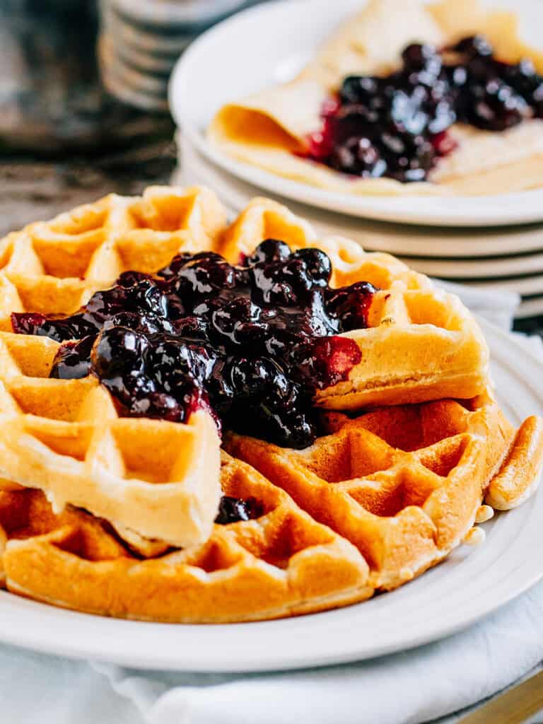 Blueberry compote on top of waffles.