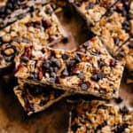 A sweet and filling Chewy granola bar on top of all the others showing of chopped pecans, mini chocolate chips, and dried cranberries.