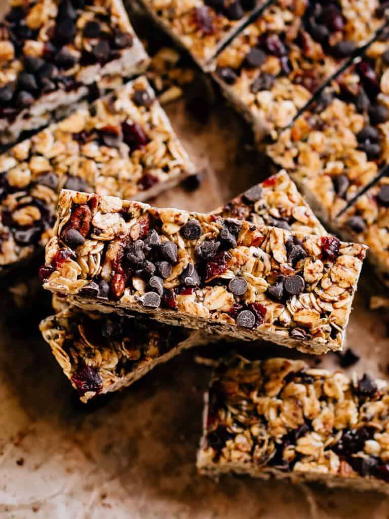 A sweet and filling Chewy granola bar on top of all the others showing of chopped pecans, mini chocolate chips, and dried cranberries.