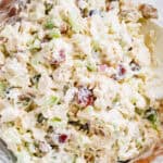 Complete easy chicken salad dish with a creamy dressing covering cooked chicken, red grapes, celery, and red onion.