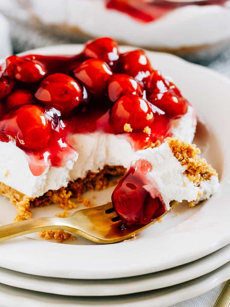 A in forkful of the dessert in focus showing off the delicious layers.