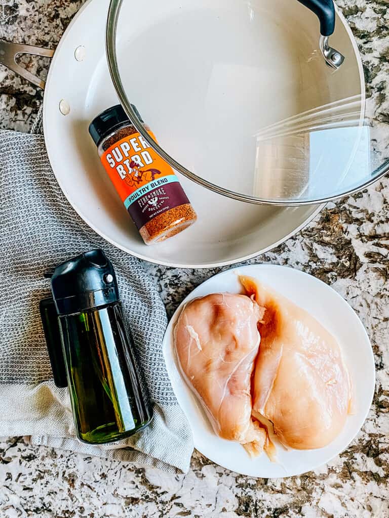 Ingredients for the BEST Pan-Fried Chicken Breasts. Seasoning blend, boneless, skinless chicken breasts, oil and water.
