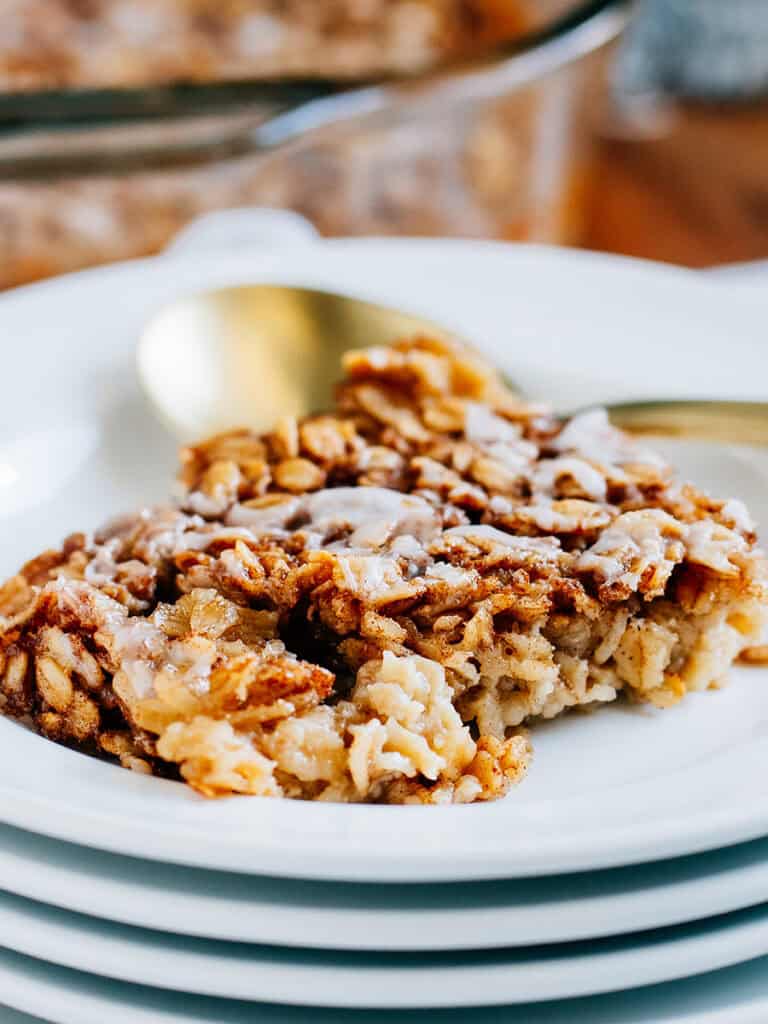 Softened hearty oats covered in sweet cinnamon sugar drizzled with a simple glaze plated and ready to eat.