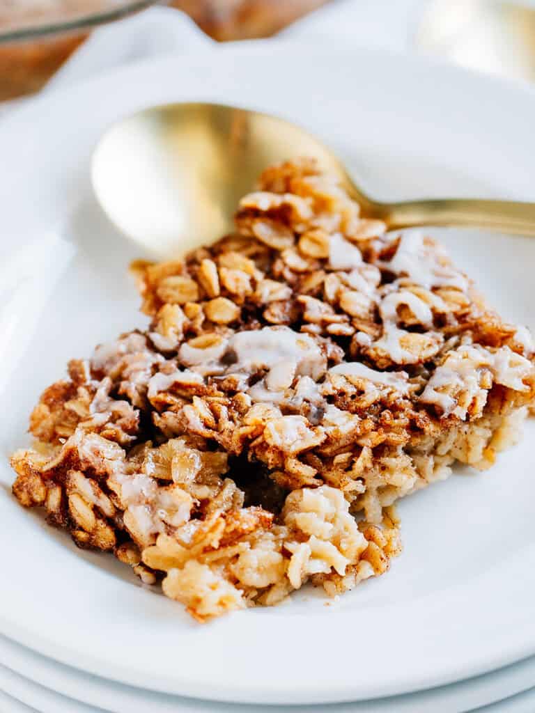 Overview: Softened hearty oats covered in sweet cinnamon sugar drizzled with a simple glaze plated and ready to eat.
