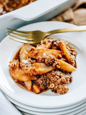 Tender cinnamon sugar apples with a buttery brown sugar and oat crumble, this apple crisp is plated and ready to be enjoyed.