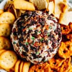 Delicious and easy this is a festive Cranberry Pecan Cheese Ball is surrounded by our favorite crackers and pretzels.