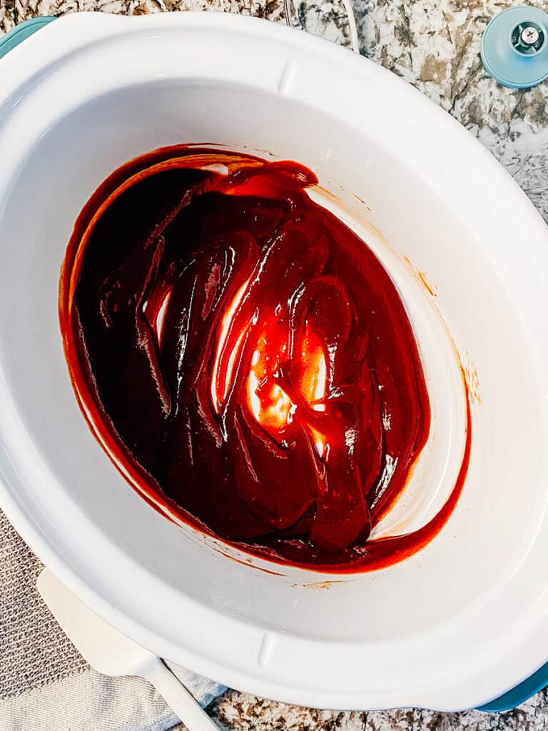 The sauce for these little smokies mixed at the bottom of the slow cooker.