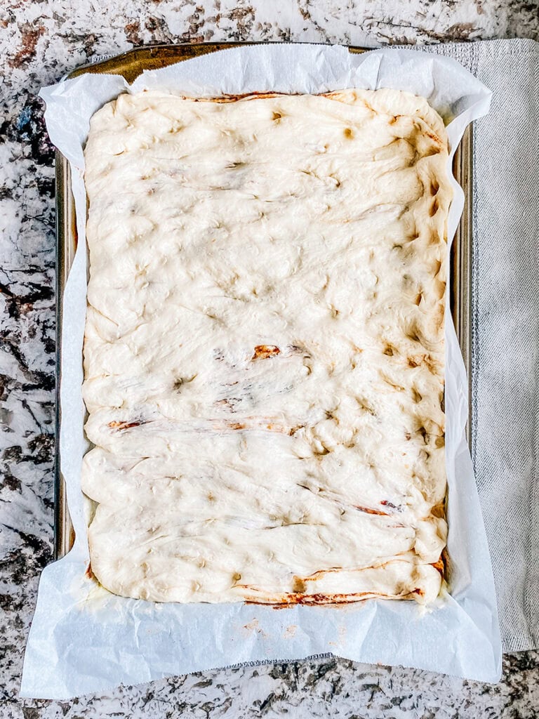 The risen bread stretched out once more to fit the pan.
