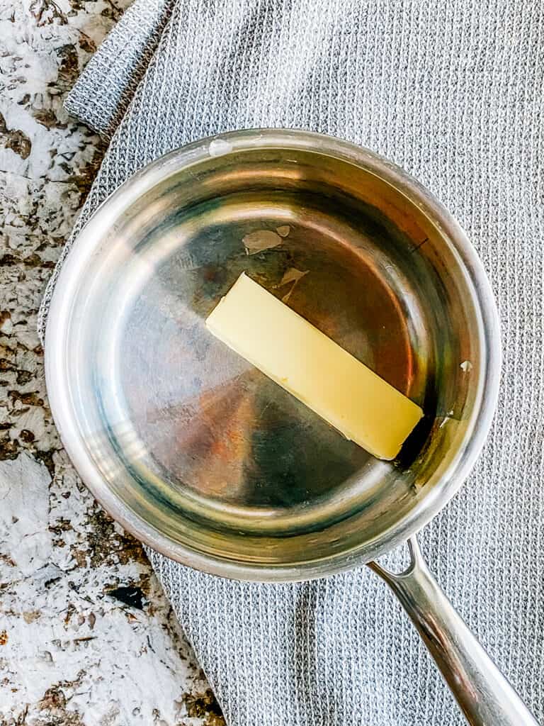 One stick of butter in a saucepan.