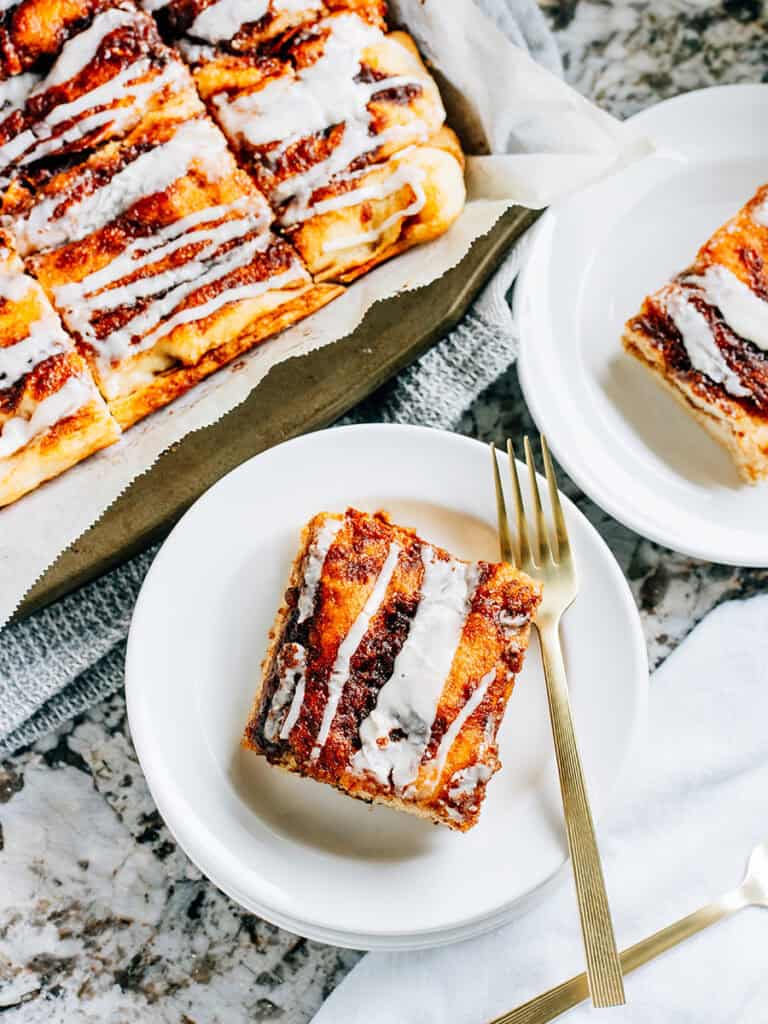 Two plates of bread with cinnamon sugar swirls shot from above.