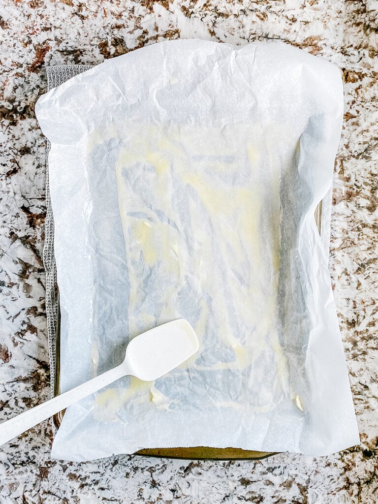 A large sheet pan lined with parchment paper and greased with melted butter.