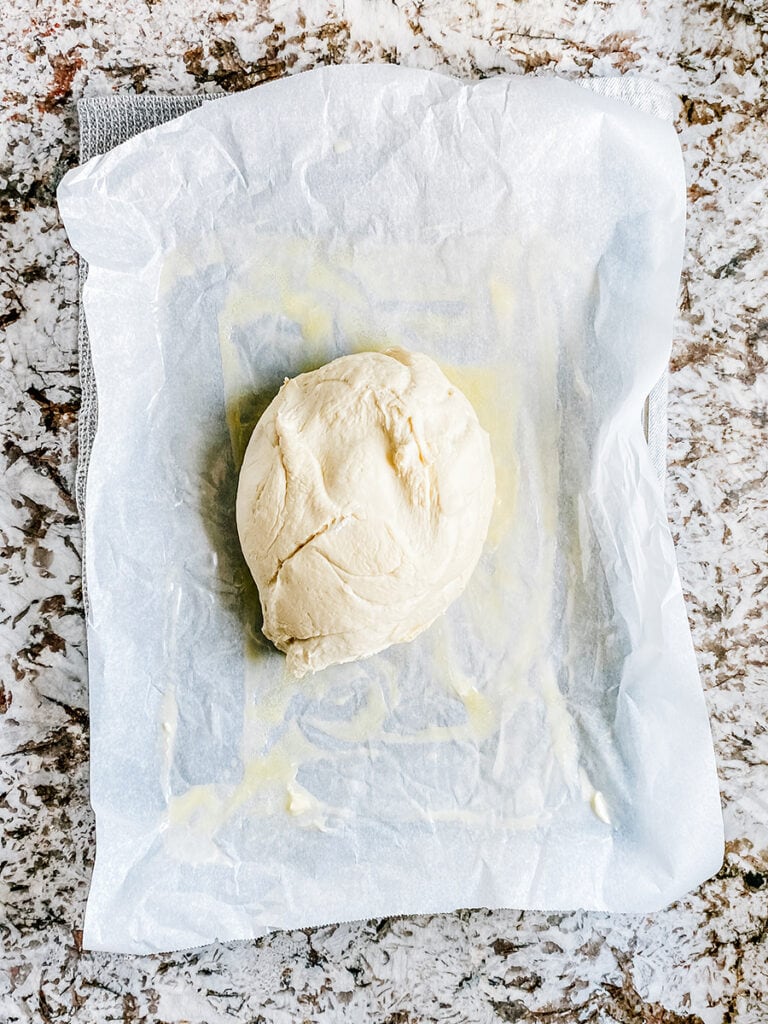 The bread dough ball turned out onto the prepared sheet pan.