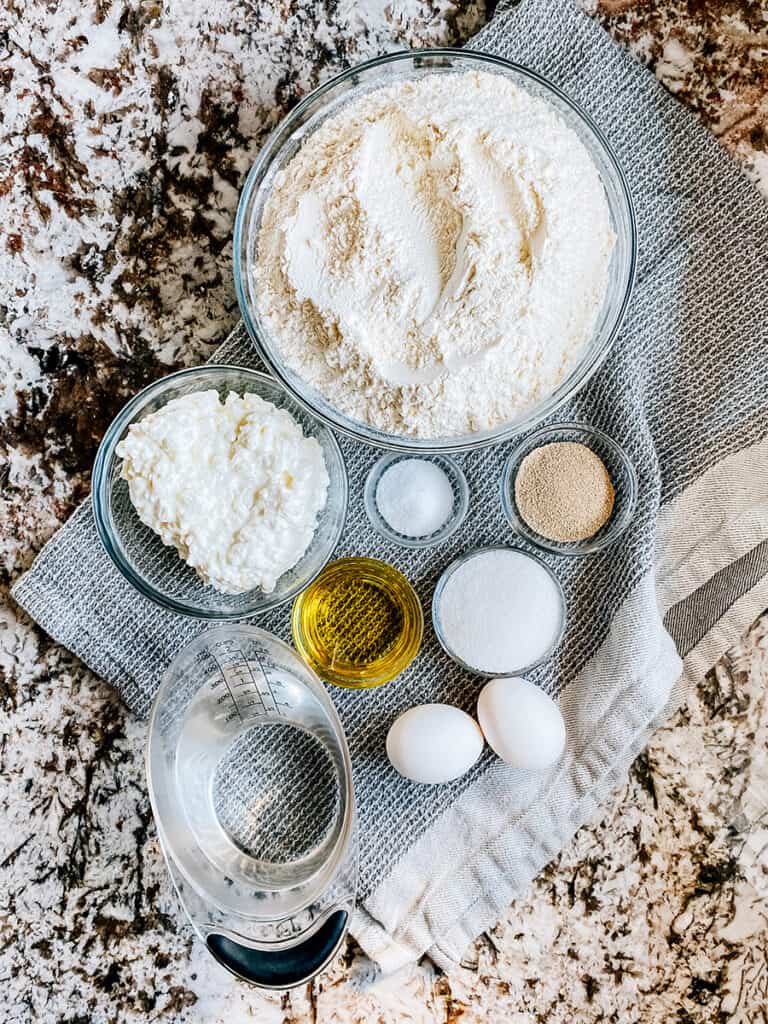 Ingredients to cottage cheese bread recipe: Flour, salt, oil, yeast, sugar, water, eggs, and cottage cheese.
