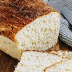 A close up showing the sliced end of a cottage cheese bread loaf.