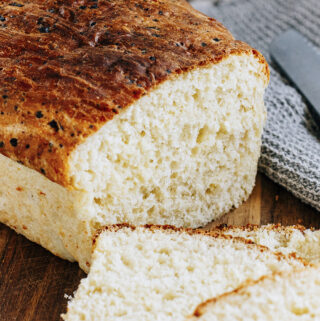 A close up showing the sliced end of a cottage cheese bread loaf.