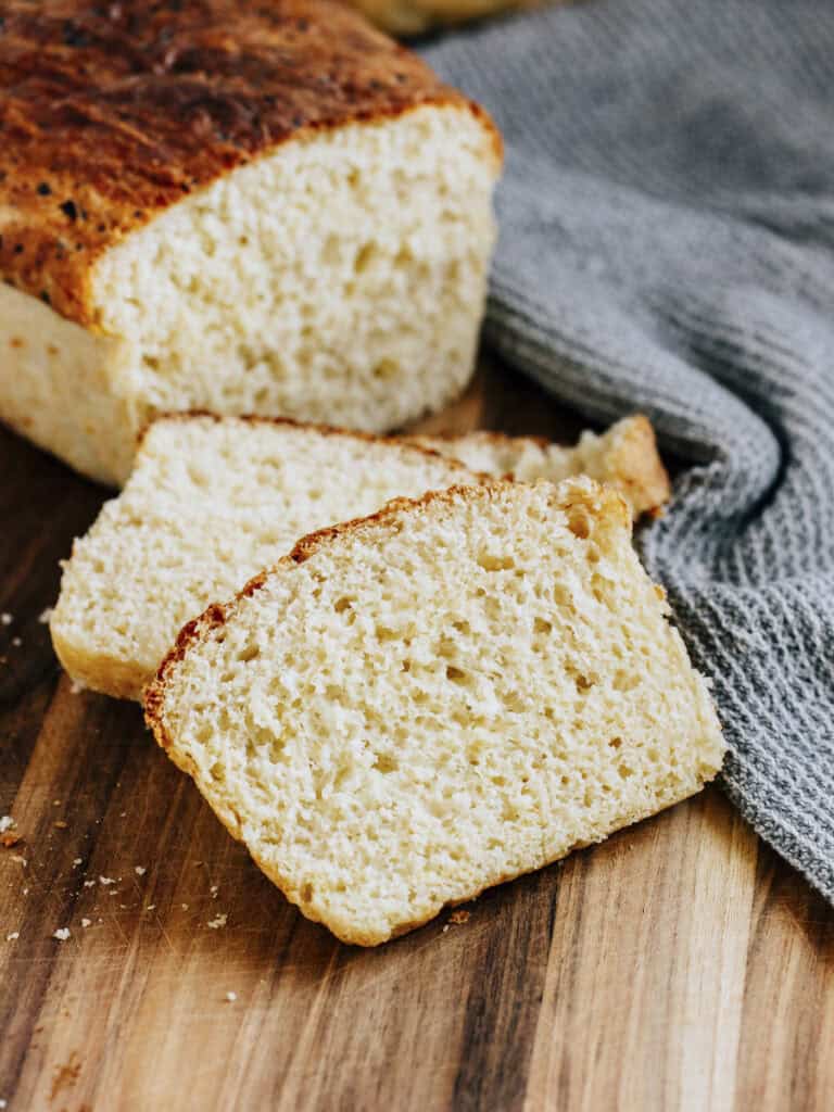 A piece of homemade bread laying on a cutting board.