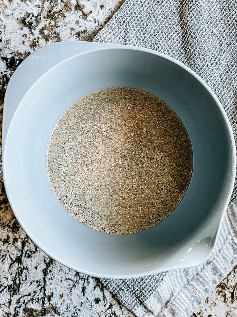 Active dry yeast on top of the sugar and water.