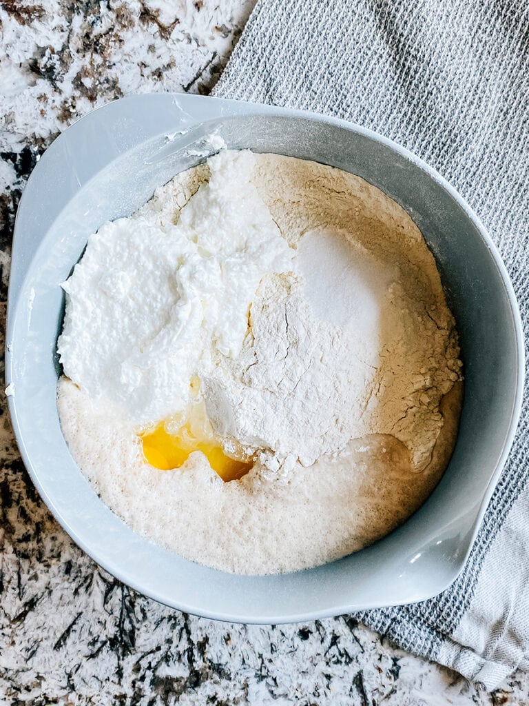The flour, oil, salt, eggs, and cottage cheese added to the yeast mixture.