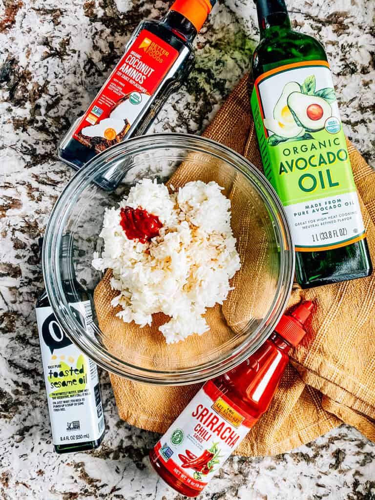 Ingredients for the crispy rice in a Crispy Rice Salad recipe: Cooked and cool rice, oil, soy sauce, sesame oil, and sriracha sauce.