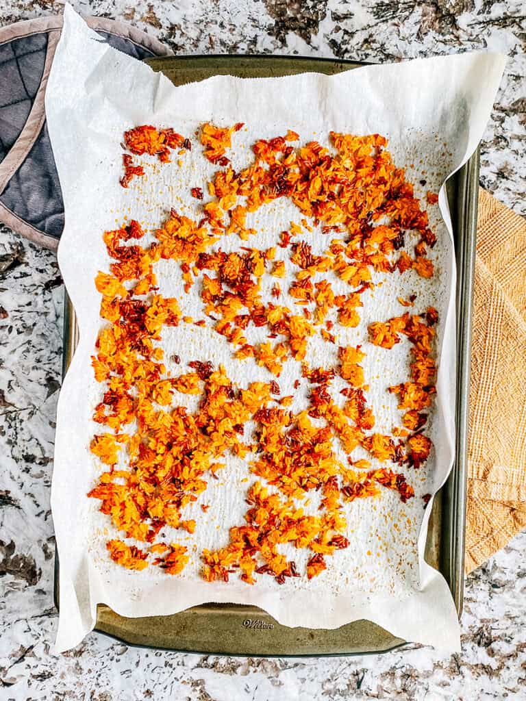 The golden brown crispy rice on a baking sheet cooling.