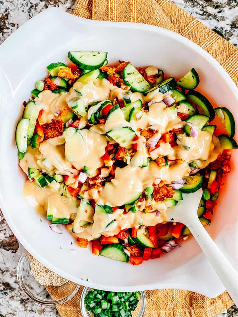 The spicy mayo dressing drizzled on the salad.