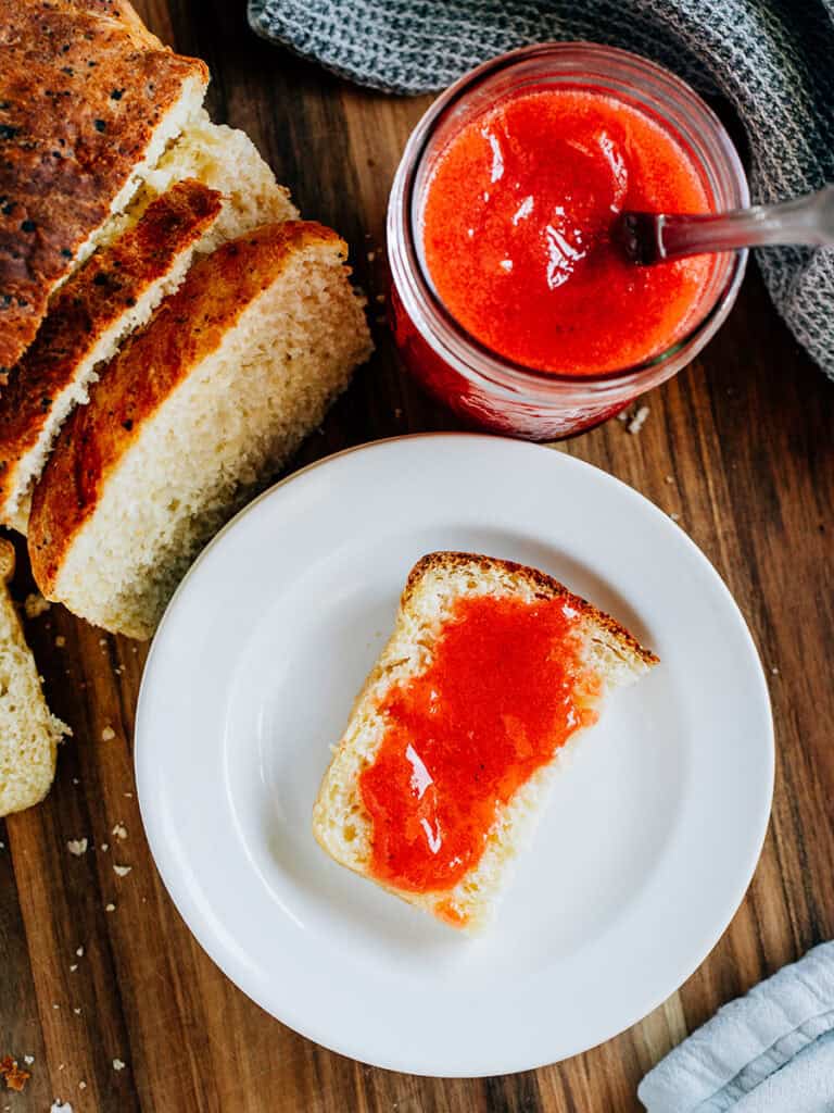 Over view of the jelly bread made with cottage cheese bread and strawberry jam and a jar of jam on the side.