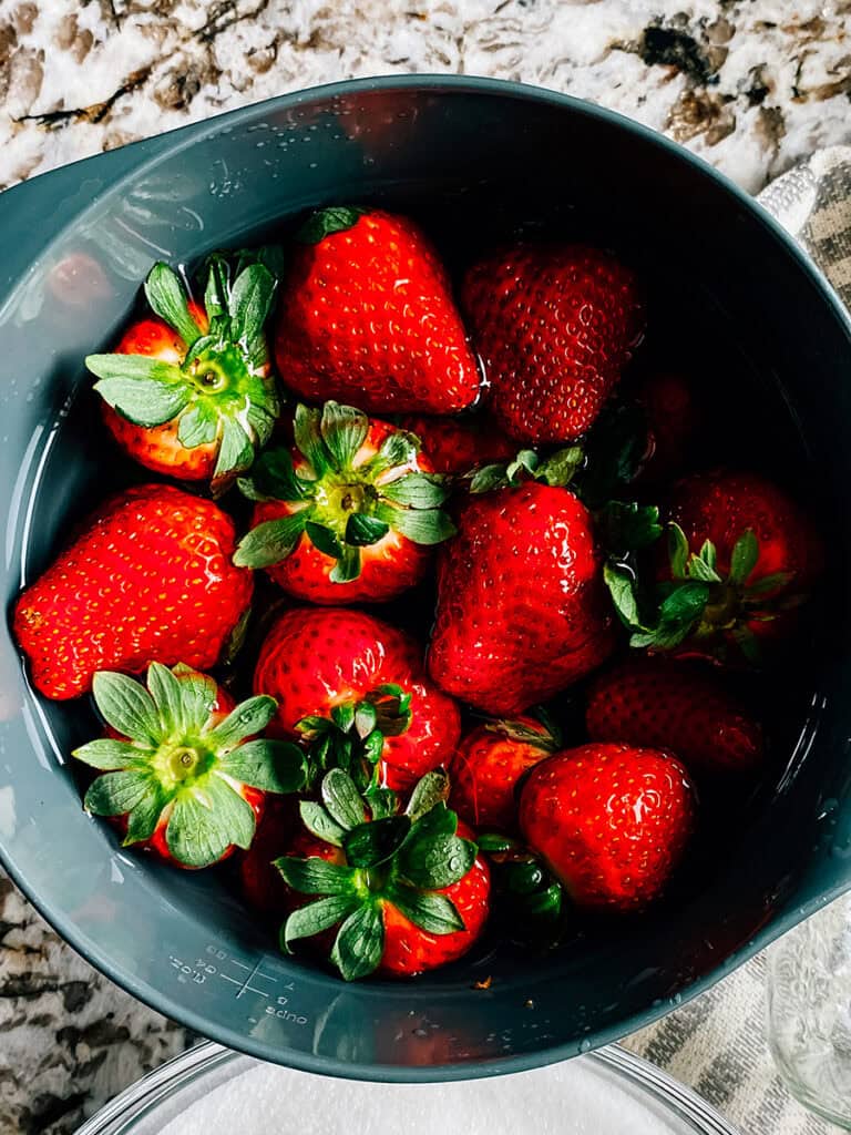 Fresh strawberries in a bowl prepared to be washed.