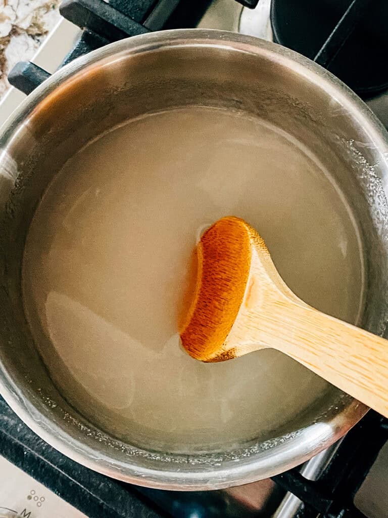 Sure-Jell pectin and water mixed in a saucepan on the stove over high heat.