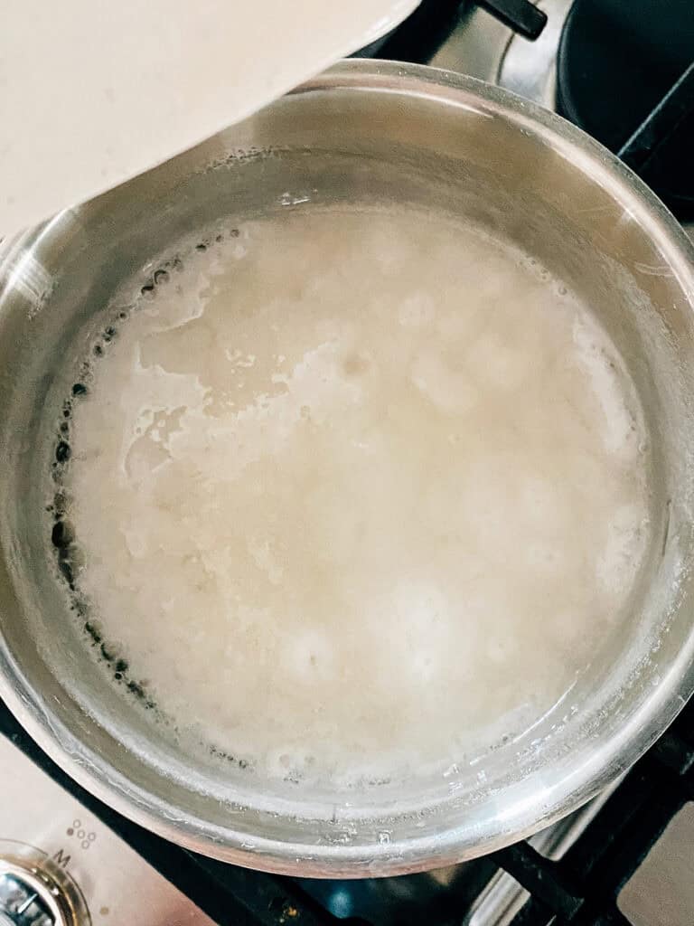Boiling Sure-Jell pectin and water on the stove.