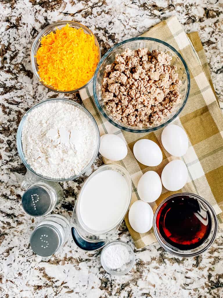 The ingredients for this McGriddle-inspired breakfast bake: Browned sausage, eggs, pancake mix, cheese, milk, maple syrup, baking powder, salt, and pepper.
