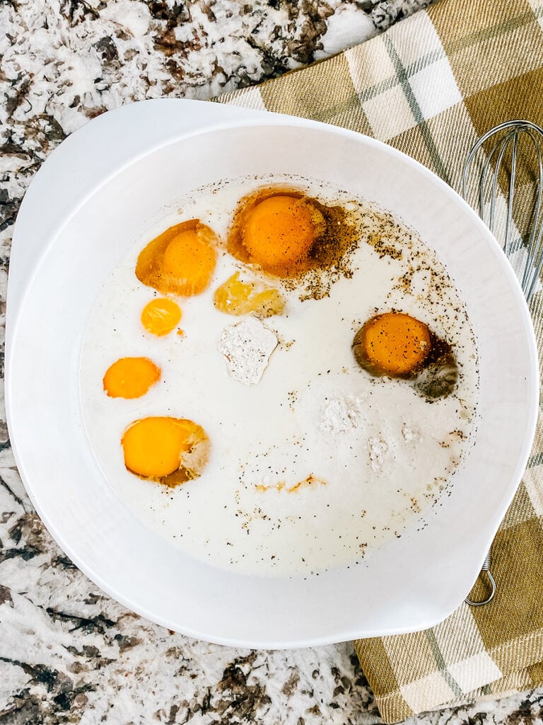 Pancake mix, milk, eggs, maple syrup, baking powder, salt, and pepper in a large mixing bowl.
