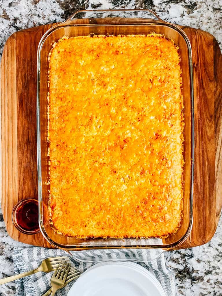 The cooling breakfast bake with syrup, plates and forks.