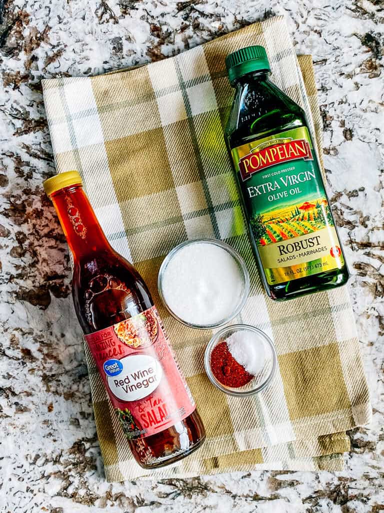 The cowboy caviar dressing ingredients: olive oil, red or white wine vinegar, sugar, salt, and chili powder.