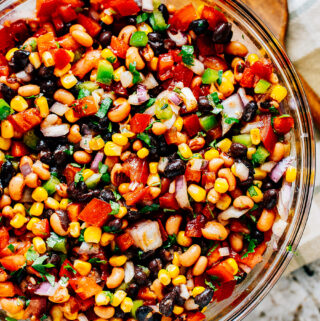 Completely mixed fresh cowboy caviar chip dip in a large glass bowl.