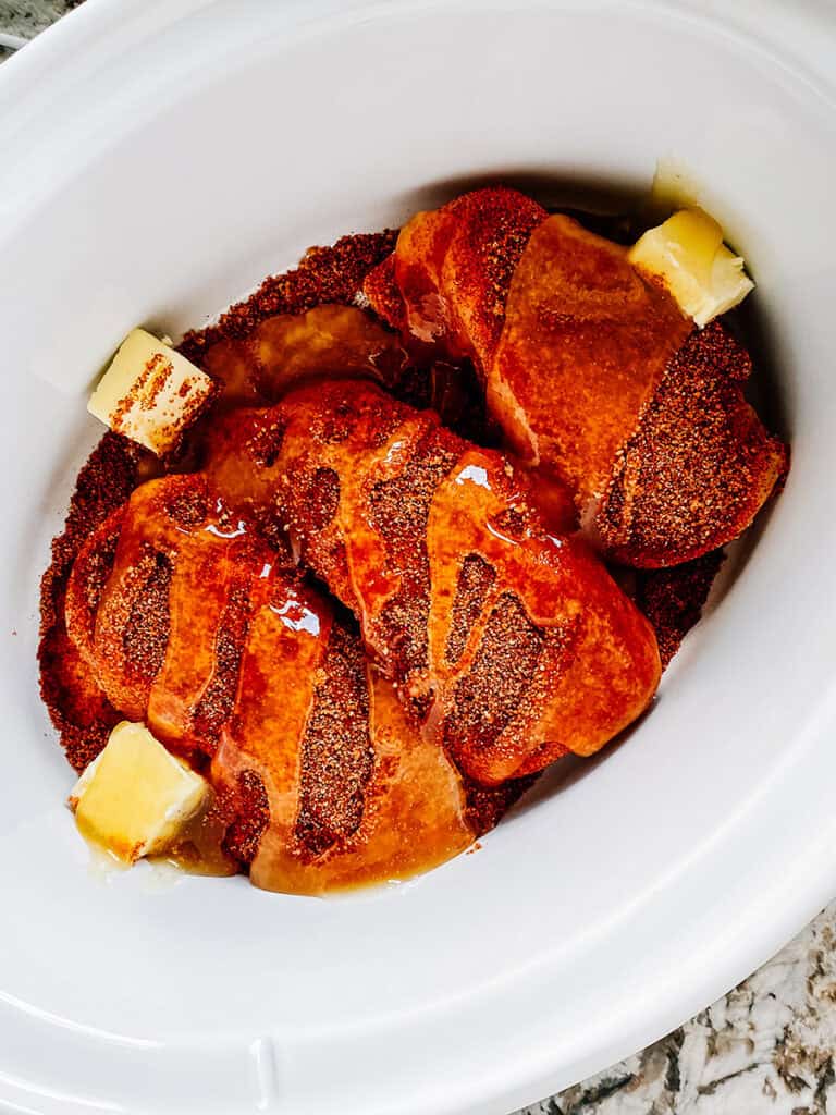 The honey drizzled on top of the seasoned chicken and butter.